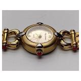 Oleg Cassini 32-420 quartz watch. Quartz watch with plain band and rhinestones on the dial face.