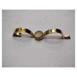 Oleg Cassini 32-420 quartz watch. Quartz watch with plain band and rhinestones on the dial face.