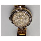 Oleg Cassini 32-420 quartz watch. Quartz watch with plain band and rhinestones on the dial face.