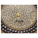 Oleg Cassini 32-420 quartz watch. Quartz watch with plain band and rhinestones on the dial face.