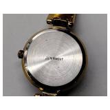 Oleg Cassini 32-420 quartz watch. Quartz watch with plain band and rhinestones on the dial face.