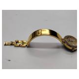 Oleg Cassini 32-420 quartz watch. Quartz watch with plain band and rhinestones on the dial face.