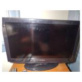 Insignia TV and Panasonic DVD player with remotes.