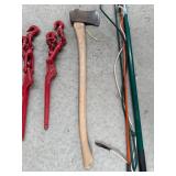 Collection of Farm Tools and Equipment including Chains, Axe, and Stakes