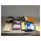 Assortment of Office Supplies including Address Labels, Paper, and Envelopes