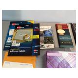 Assortment of Office Supplies including Address Labels, Paper, and Envelopes