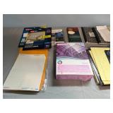 Assortment of Office Supplies including Address Labels, Paper, and Envelopes