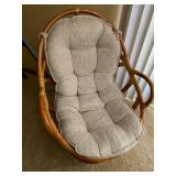 Rattan Swivel Chair with Cushion and Red Accent Pillow
