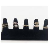 Group of 8 Gold Tone Base Metal Rings. Size 8.75-9.75.