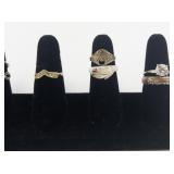 Group of 8 Gold Tone Base Metal Rings. Size 8.75-9.75.