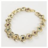 Multi-Colored Rhinestone Accented Gold Tone Base Metal Heart Link Bracelet.