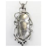 Abstract Enamel & Rhinestone Accented Silver Tone Base Metal Pendant Necklace & French Wire Earrings.