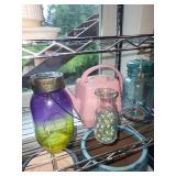 Collection of Garden Planters, Watering Cans, and Decorative Jars