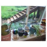 Collection of Garden Planters, Watering Cans, and Decorative Jars