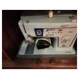 Vintage Singer Sewing Machine with Integrated Wooden Sewing Cabinet