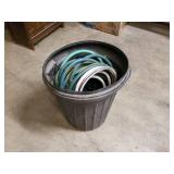 Garbage can full of garden hose