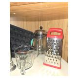 Assorted Kitchenware Collection Including Glass Bowls, Muffin Pan, and Grater