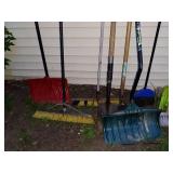 Collection of Snow Shovels, Rakes, and Brooms