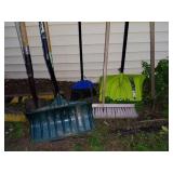 Collection of Snow Shovels, Rakes, and Brooms