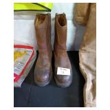 Assorted Workwear Including Carhartt Coveralls, Safety Vest, Boots, and Rain Suit