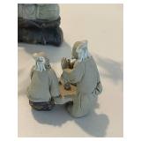 Stone Buddha Statue and Three Wise Men Figurines