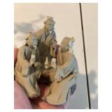 Stone Buddha Statue and Three Wise Men Figurines