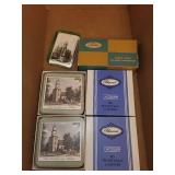 Assorted Home Decor Items Including Coasters, Candle, Piggy Bank, and Handbell