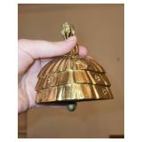 Assorted Home Decor Items Including Coasters, Candle, Piggy Bank, and Handbell