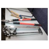 Collection of Hand Tools Including Pruning Shears, Bow Saw, and Hacksaw