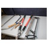 Collection of Hand Tools Including Pruning Shears, Bow Saw, and Hacksaw