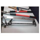 Collection of Hand Tools Including Pruning Shears, Bow Saw, and Hacksaw