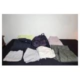 Assortment of Clothing and Gear Including Pants, Backpack, and Towels