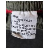 Assortment of Clothing and Gear Including Pants, Backpack, and Towels