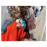 Bin of shirts, pants, belts, socks