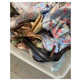Bin of shirts, pants, belts, socks