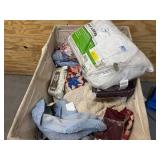 Bin of pillows, blankets, bed sheets, sofa covers