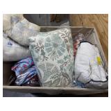 Bin of pillows, blankets, bed sheets, sofa covers