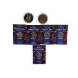 Two Ike dollar coins, one of which is an uncirculated 1976 edition, as well as five uncirculated state quarters.