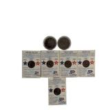 Two Ike dollar coins, one of which is an uncirculated 1976 edition, as well as five uncirculated state quarters.