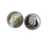 Two Ike dollar coins, one of which is an uncirculated 1976 edition, as well as five uncirculated state quarters.