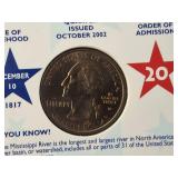 Two Ike dollar coins, one of which is an uncirculated 1976 edition, as well as five uncirculated state quarters.