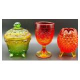 Fenton Amberina Hobnail Three Footed Egg, L.E. Smith Amberina Grape & Leaf Pattern Water Glass, and Jeanette Glass Covered Candy Dish