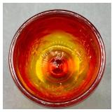 Fenton Amberina Hobnail Three Footed Egg, L.E. Smith Amberina Grape & Leaf Pattern Water Glass, and Jeanette Glass Covered Candy Dish