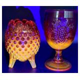 Fenton Amberina Hobnail Three Footed Egg, L.E. Smith Amberina Grape & Leaf Pattern Water Glass, and Jeanette Glass Covered Candy Dish