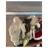 Collection of Santa Claus Figurines and Christmas Decorations