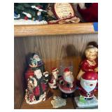 Collection of Santa Claus Figurines and Christmas Decorations