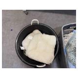 Bin of rugs, pillows, bedsheets