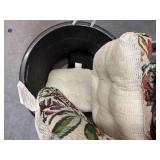 Bin of rugs, pillows, bedsheets