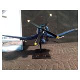 Replica of a fire bomber F4U-4 Corsair plane on stand and in original box