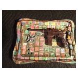 Replica of a WW1 German Mauser on a brass tray of German stamps